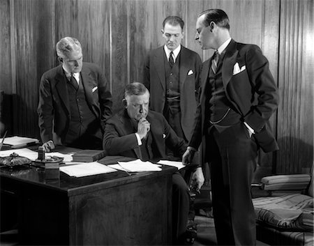 simsearch:846-02796052,k - 1930s FOUR BUSINESSMEN CONFERENCE OFFICE SERIOUS EXPRESSIONS Stock Photo - Rights-Managed, Code: 846-02796088