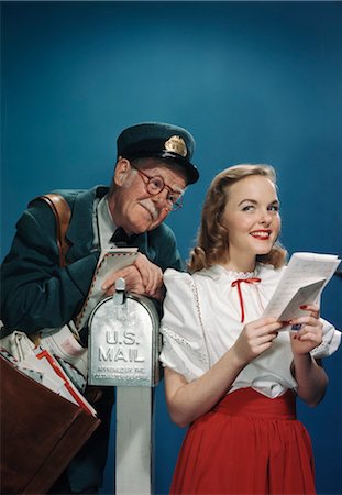 photo of a mailman in the 1950s - 1940s ELDERLY MAILMAN READING OVER THE SHOULDER OF YOUNG WOMAN HOLDING LETTER Stock Photo - Rights-Managed, Code: 846-02796116