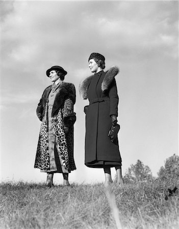 fur - 1930s 2 WOMEN POSING OUTSIDE GRASS FASHION PORTRAIT WOMAN HAT HATS FUR COAT LEOPARD STYLE FASHIONS SKY Stock Photo - Rights-Managed, Code: 846-02796192