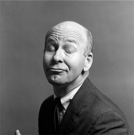 simsearch:846-02796231,k - CHARACTER BALD MAN SUIT TIE FUNNY FACE EXPRESSION WRINKLED BROW EYES CLOSED Stock Photo - Rights-Managed, Code: 846-02796232