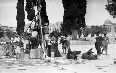 1920s 1930s LOCALS FILLING GOAT SKINS WITH WATER AT WELL IN PALESTINE JERUSALEM Stock Photo - Rights-Managed, Code: 846-02796251