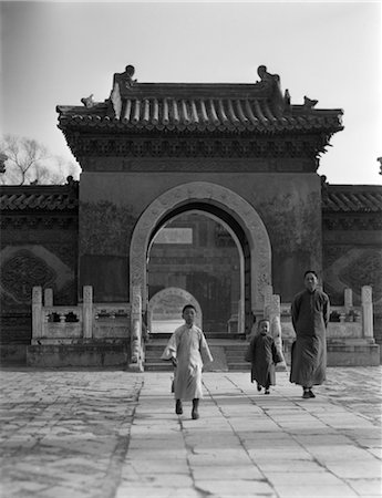 1920s 1930s CHINESE MAN 2 CHILDREN BOYS WALKING FROM TEMPLE GATEWAY ARCH WINTER PALACE PEKING BEIJING CHINA Stock Photo - Rights-Managed, Code: 846-02796296