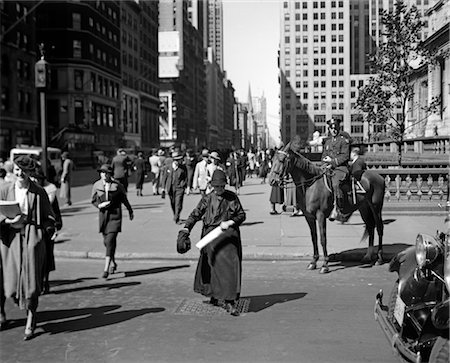 1930s MOUNTED POLICEMAN FIFTH AVENUE 40TH STREET WATCHES AS OLD WOMAN CROSSES THE STREET NEW YORK CITY USA Stock Photo - Rights-Managed, Code: 846-02796361