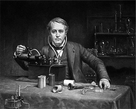 famous people in history - 1880s DRAWING OF INVENTIVE GENIUS THOMAS A. EDISON & PHONOGRAPH CYLINDRICAL INVENTION IN FRONT EDISON LISTENING ON EAR PHONES Stock Photo - Rights-Managed, Code: 846-02796397