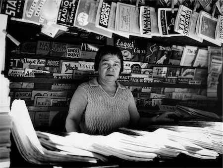 simsearch:846-02796344,k - 1930s WOMAN SELLING MAGAZINES NYC SIDEWALK NEWSSTAND NEWS STAND NEWSPAPERS 42ND STREET MADISON AVENUE NEW YORK CITY Stock Photo - Rights-Managed, Code: 846-02796497