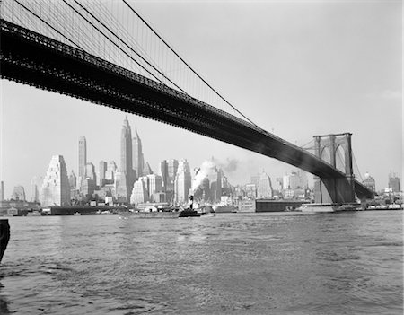 1950s SKYLINE OF LOWER MANHATTAN WITH BROOKLYN BRIDGE FROM BROOKLYN ACROSS THE EAST RIVER Stock Photo - Rights-Managed, Code: 846-02796549