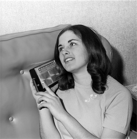 retro person listening music - BRUNETTE TEEN GIRL WOMAN LISTENING TO TRANSISTOR RADIO 1950s 1960s MUSIC Stock Photo - Rights-Managed, Code: 846-02796628