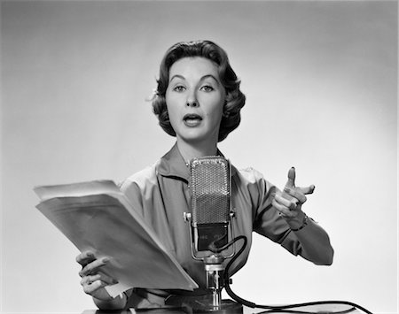 radio sign - 1950s WOMAN TALKING INTO MICROPHONE HOLDING PAPERS WITH EXAGGERATED EXPRESSION Stock Photo - Rights-Managed, Code: 846-02796669