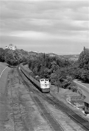 1950s OVERHEAD VIEW OF STREAMLINED DIESEL LOCOMOTIVE PASSENGER RAILROAD TRAIN PASSING THROUGH SUBURBAN Stock Photo - Rights-Managed, Code: 846-02796680