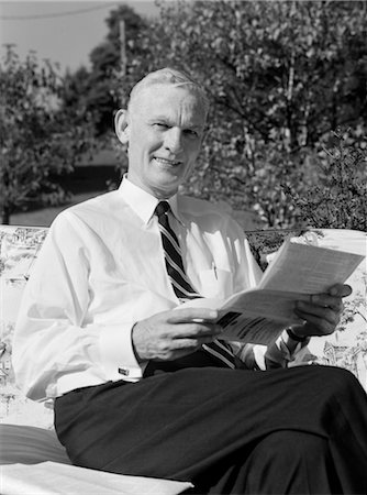 1960s ELDERLY MAN IN SHIRT & TIE SITTING ON LAWN FURNITURE READING PAMPHLET Stock Photo - Rights-Managed, Code: 846-02796904