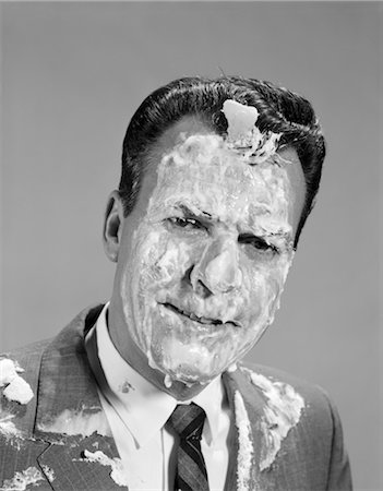 1960s PORTRAIT MAN COVERED IN MERINGUE SHAVING CREAM PIE IN THE FACE FUNNY ANGRY EXPRESSION Stock Photo - Rights-Managed, Code: 846-02796985