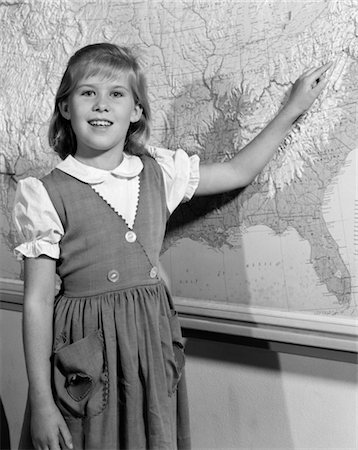 1960s GRADE SCHOOL GIRL AT FRONT OF CLASS POINTING TO MAP OF UNITED STATES Stock Photo - Rights-Managed, Code: 846-02797029