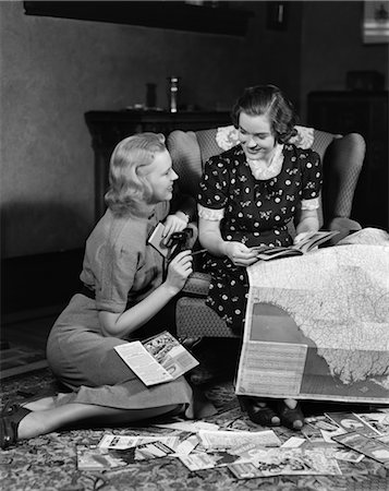 1930s 1940s TWO WOMEN READING MAPS AND TRAVEL BROCHURES SMILING PLANNING VACATION TRAVEL CHAIR Stock Photo - Rights-Managed, Code: 846-02797020