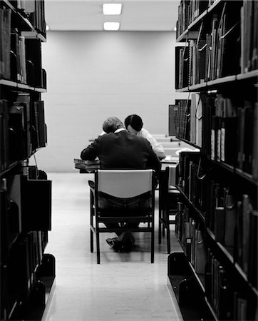 simsearch:846-02796739,k - 1970s PAIR OF MALE COLLEGE STUDENTS STUDYING IN LIBRARY FRAMED BY BOOKSHELVES Stock Photo - Rights-Managed, Code: 846-02797066