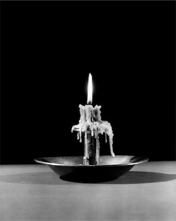 STILL LIFE OF LIT CANDLE BURNED ALMOST ALL THE WAY DOWN DRIPPING WAX Stock Photo - Rights-Managed, Code: 846-02797091