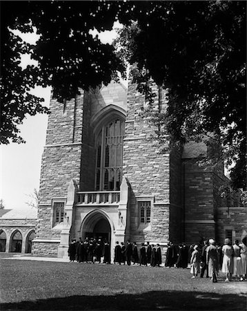 simsearch:846-02797214,k - 1930s LINE OF GRADUATES FILING INTO LARGE STONE CAMPUS BUILDING Stock Photo - Rights-Managed, Code: 846-02797119
