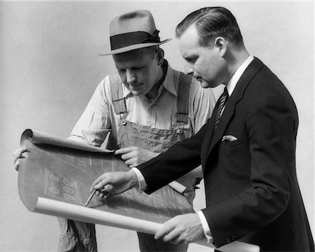 1930s MAN IN SUIT GOING OVER BLUE PRINTS WITH A CUSTOMER Stock Photo - Rights-Managed, Code: 846-02797276