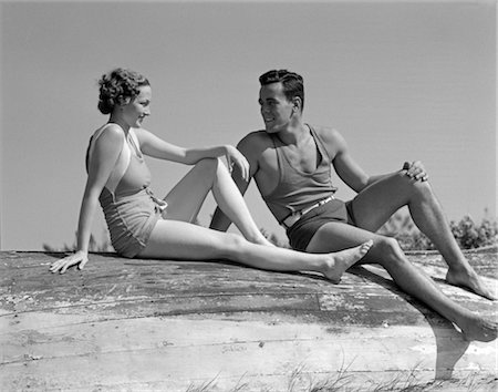 suit pool - 1930s COUPLE IN BATHING SUITS SITTING NEAR BEACH Stock Photo - Rights-Managed, Code: 846-02797308