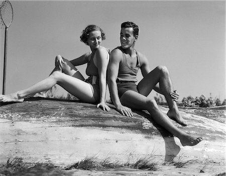 1950s BATHING BEAUTY IN SATIN ONE PIECE SITTING ON DIVING BOARD