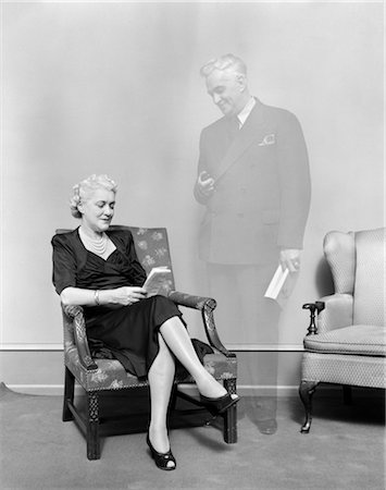 simsearch:846-02797224,k - 1930s ELDERLY WOMAN SITTING IN CHAIR GHOSTLY FIGURE OF MAN STANDING LOOKING AT HER Stock Photo - Rights-Managed, Code: 846-02797314