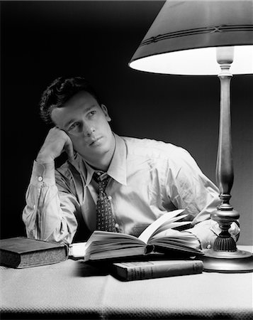 simsearch:846-02793574,k - 1940s YOUNG MAN LEANING ON ELBOW STUDYING Stock Photo - Rights-Managed, Code: 846-02797342