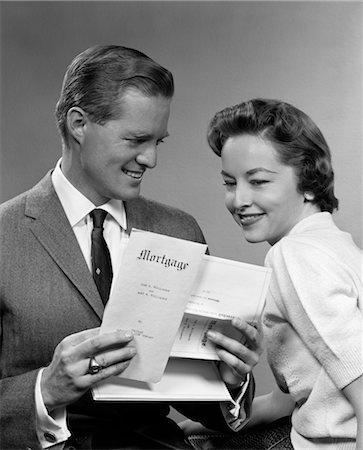 1950s SMILING PORTRAIT COUPLE LOOKING AT COPY OF NEW MORTGAGE Stock Photo - Rights-Managed, Code: 846-02797371