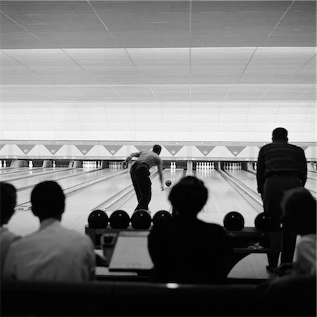 1940s 1950s BOWLING ALLEY SHOWING LANES MAN BOWLING SILHOUETTED CROWD WATCHING Stock Photo - Rights-Managed, Code: 846-02797389