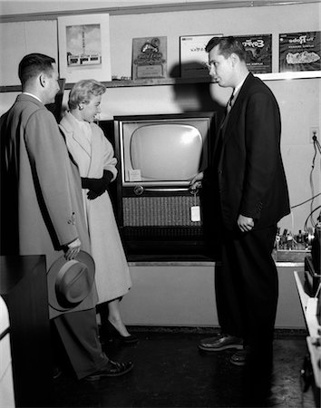 simsearch:846-02795210,k - 1950s COUPLE WITH SALESMAN IN ELECTRIC APPLIANCE STORE SHOPPING FOR TELEVISION Stock Photo - Rights-Managed, Code: 846-02797383