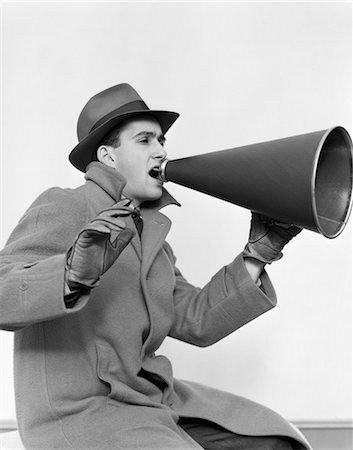 simsearch:846-02797853,k - 1940s MAN IN COAT HAT AND GLOVES YELLING IN MEGAPHONE Stock Photo - Rights-Managed, Code: 846-02797409