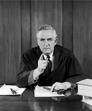 simsearch:846-02797439,k - 1950s JUDGE AT BENCH POINTING AT CAMERA WITH STERN LOOK & OTHER HAND OVER GAVEL Stock Photo - Rights-Managed, Code: 846-02797439