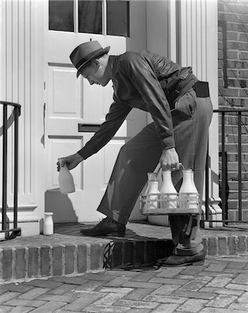 1940s MILKMAN SETTING GLASS BOTTLES OF MILK AND CREAM IN FRONT OF DOOR Stock Photo - Rights-Managed, Code: 846-02797445