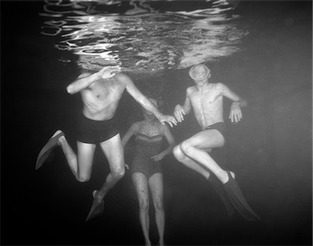 swimming pool people b&w - 1950s VIEW OF THREE SWIMMERS UNDER WATER Stock Photo - Rights-Managed, Code: 846-02797475