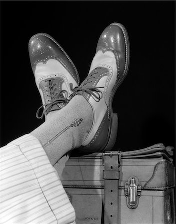 elegant male shoes - 1930s 1940s CROSSED FEET OF A MAN WEARING TWO TONE WING TIP SPECTATOR SHOES SILK SOCKS AND STRIPED WHITE WOOL CUFFED TROUSERS Stock Photo - Rights-Managed, Code: 846-02797501