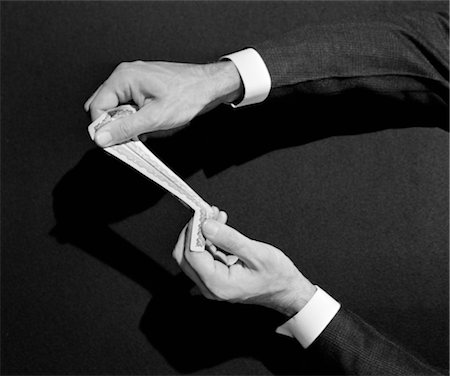 stretching a dollar - 1940s MAN'S HANDS PERFORMING MAGIC TRICK WITH MONEY STRETCHING A DOLLAR Stock Photo - Rights-Managed, Code: 846-02797516