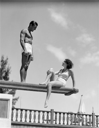 retro sport images - 1930s COUPLE BY SWIMMING POOL ON DIVING BOARD TALKING Stock Photo - Rights-Managed, Code: 846-02797542