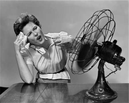1950s WOMAN SITTING IN FRONT OF FAN WIPING FOREHEAD VERY HOT Stock Photo - Rights-Managed, Code: 846-02797562