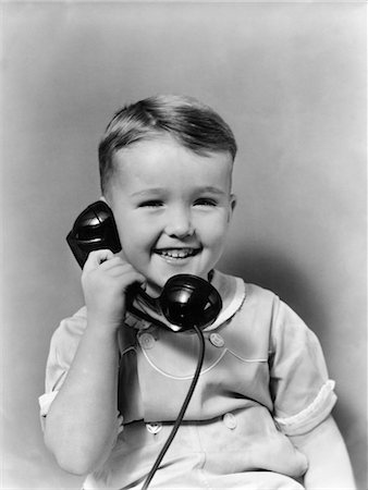 1930s LITTLE BOY SMILING TALKING ON TELEPHONE Stock Photo - Rights-Managed, Code: 846-02797674