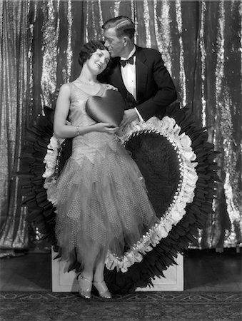 1920s MAN KISSING WOMAN HOLDING SATIN VALENTINE HEART Stock Photo - Rights-Managed, Code: 846-02797732