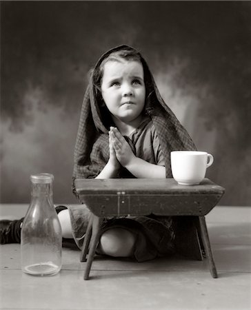 poor humanity - 1930s 1940s SAD LITTLE GIRL SHAWL OVER HAIR HANDS PRAYING Stock Photo - Rights-Managed, Code: 846-02797789