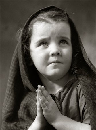 poverty child - 1930s 1940s SAD LITTLE GIRL SHAWL OVER HAIR HANDS PRAYING Stock Photo - Rights-Managed, Code: 846-02797790