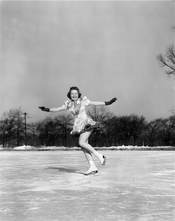 1940s SMILING WOMAN ON ICE OUTDOORS ICE SKATING ARMS OUT ABOUT TO DO BACKWARD JUMP Stock Photo - Rights-Managed, Code: 846-02797829