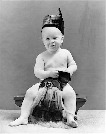 simsearch:846-03166353,k - 1940s BABY SEATED ON STOOL WEARING SCOTTISH COSTUME REACHING INTO CHANGE PURSE Stock Photo - Rights-Managed, Code: 846-02791951