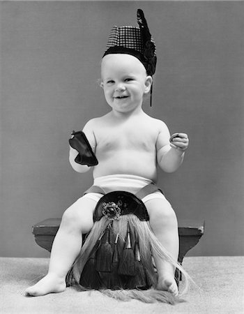 scottish - 1940s BABY IN SCOTTISH GARB SITTING ON STOOL TAKING COIN OUT OF CHANGE PURSE Stock Photo - Rights-Managed, Code: 846-02791952
