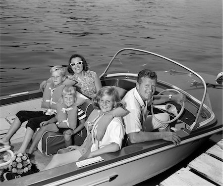 simsearch:846-02792260,k - 1960s SMILING FAMILY OF FIVE IN DOCKED BOAT CHILDREN WEARING LIFE VESTS Stock Photo - Rights-Managed, Code: 846-02791982