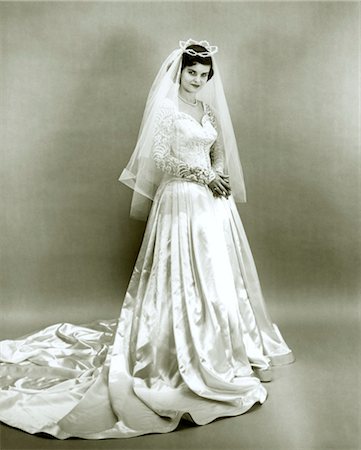 1950s FULL LENGTH PORTRAIT BRIDE STANDING WEARING WEDDING GOWN VEIL TIARA HEADPIECE Stock Photo - Rights-Managed, Code: 846-02792067