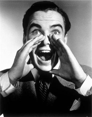 exaggerating - 1940s 1950s EXCITED MAN WITH HANDS CUPPED AROUND MOUTH SHOUTING Stock Photo - Rights-Managed, Code: 846-02792159