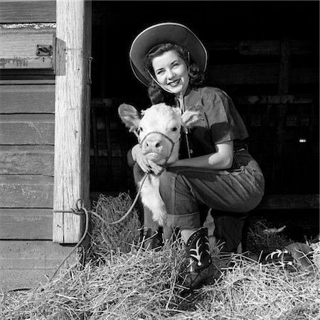 simsearch:846-02792742,k - GIRL POSING WITH CALF IN STRAW FILLED STALL IN BARN Foto de stock - Con derechos protegidos, Código: 846-02792215