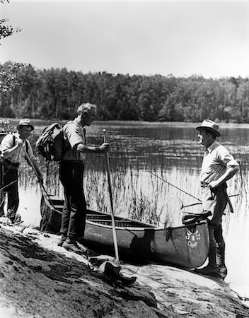 1930s 3 MEN STANDING BESIDE CANOE ON LAKE HOLDING FISHING GEAR NET BACKPACK LAKE OF THE WOODS ONTARIO Stock Photo - Rights-Managed, Code: 846-02792306