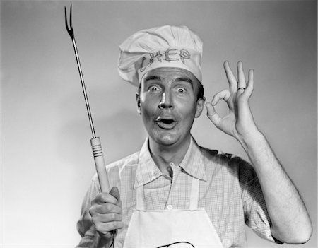 1950s 1960s MAN WEAR CHEF HAT TOQUE MAKING OKAY SIGN HOLDING BBQ GRILL FORK Stock Photo - Rights-Managed, Code: 846-02792307