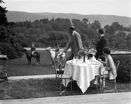 1930s COUNTRY CLUB WITH COUPLE EATING OUTSIDE & ANOTHER COUPLE ON HORSEBACK Foto de stock - Con derechos protegidos, Código: 846-02792362